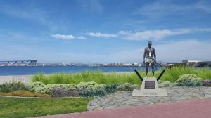 a statue in front of a body of water