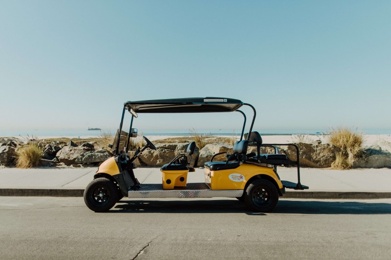 6 Passenger Golf Cart – Hourly Rental Image 1 a truck is parked on the side of a road