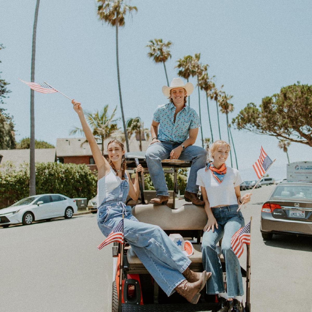 a group of people riding on the back of a car
