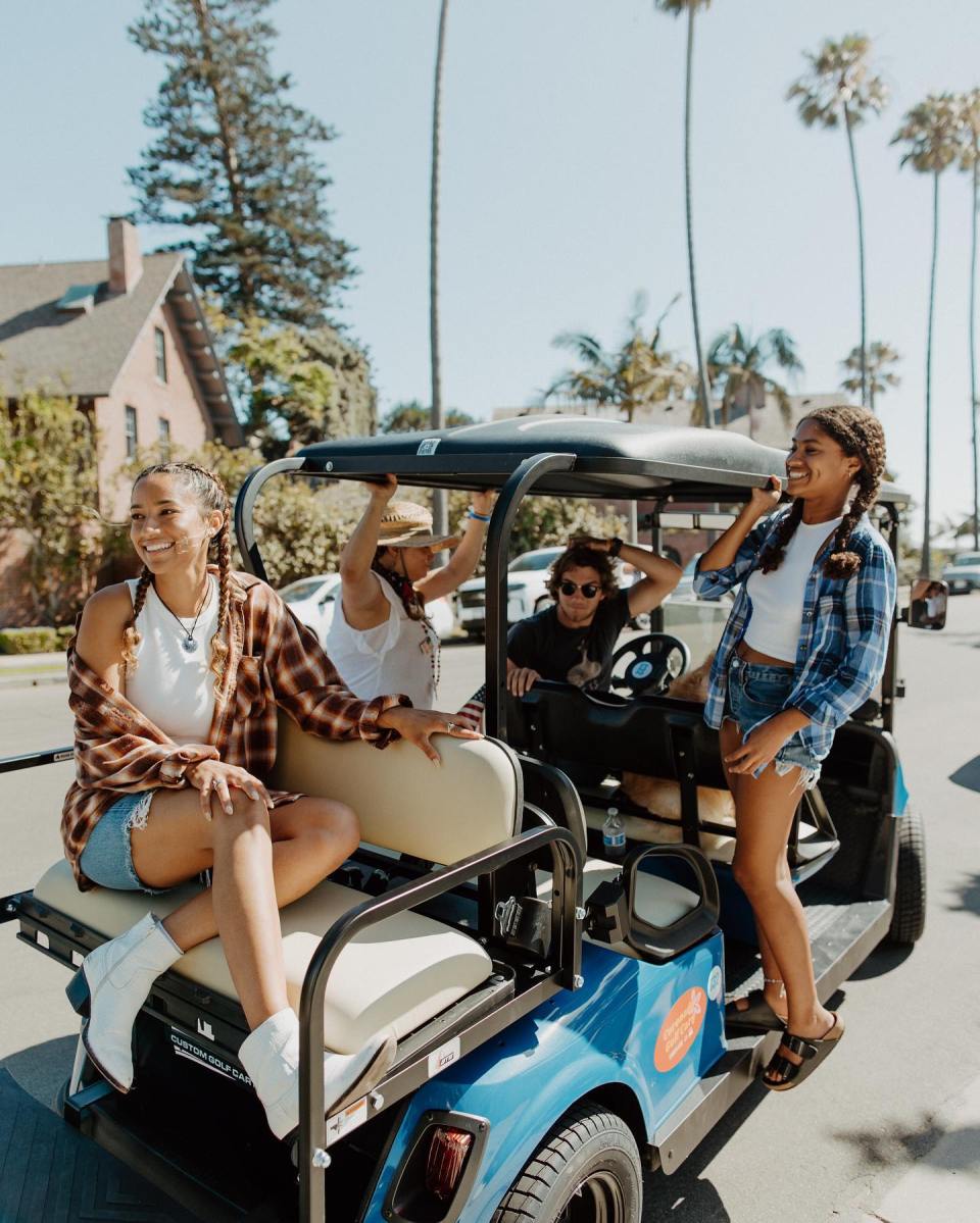a group of people riding on the back of a truck