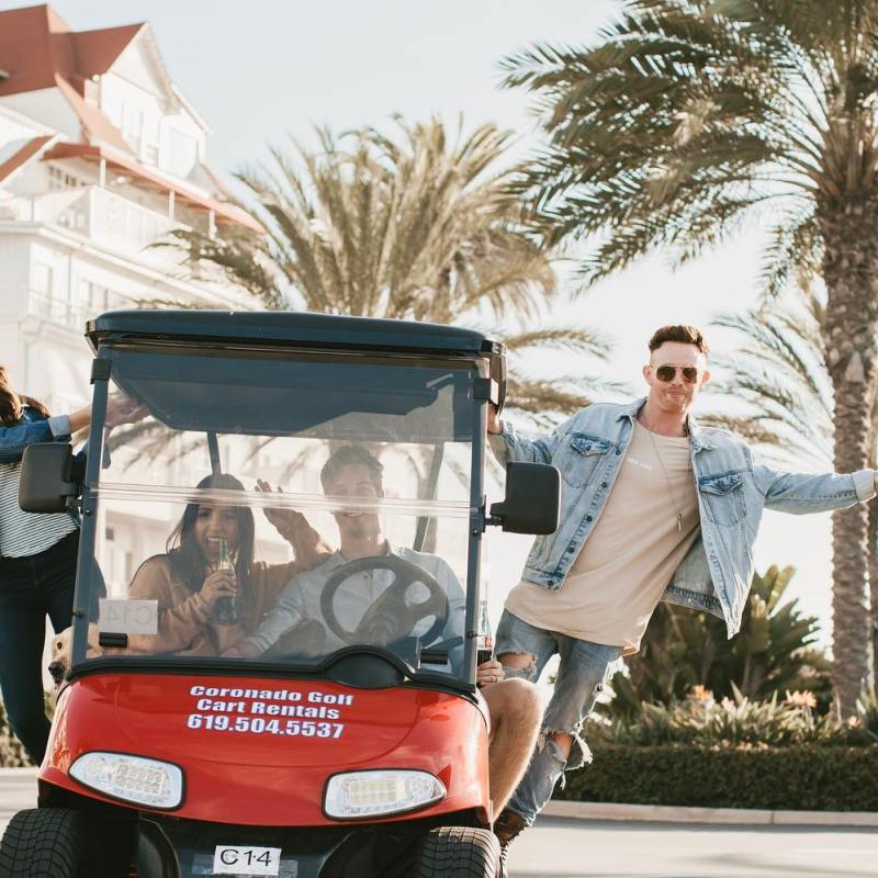 a person riding a motorcycle in front of a building