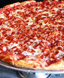 a pizza sitting on top of a metal pan