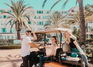 a couple of people that are standing in front of a palm tree
