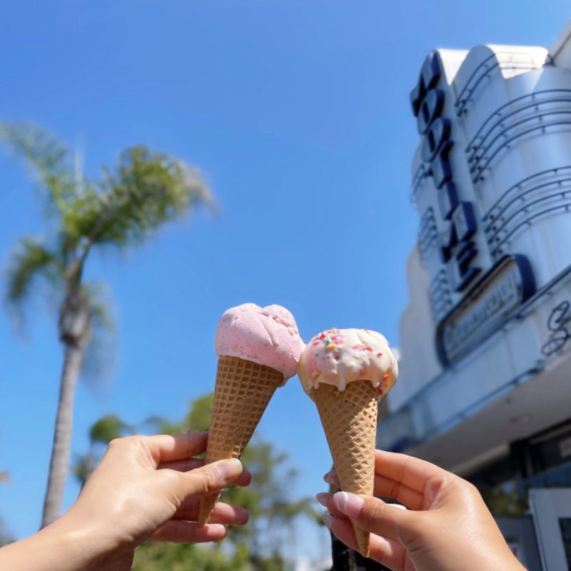 a hand holding an ice cream cone