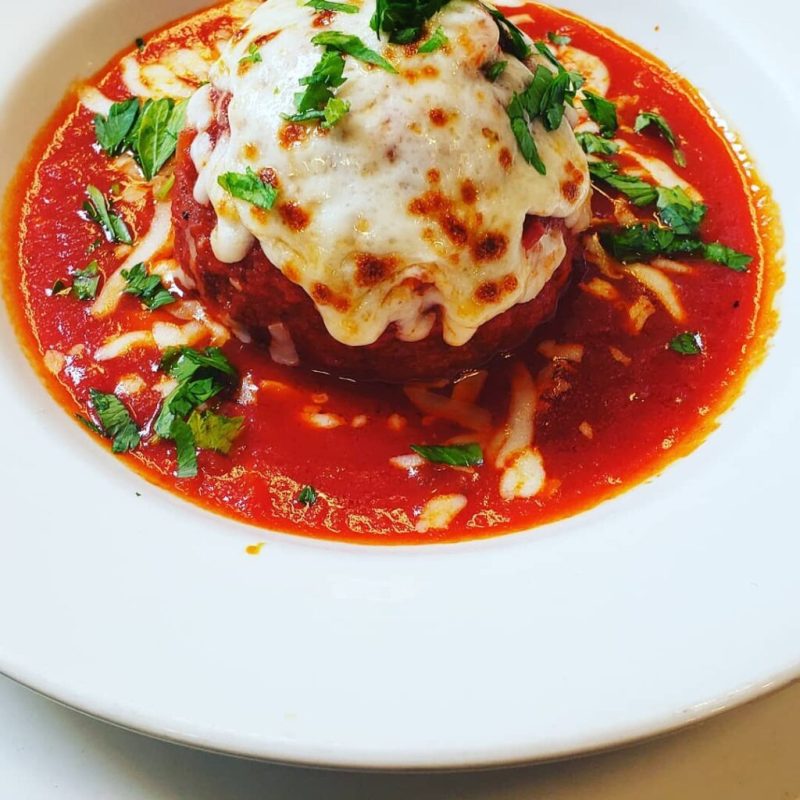 a pizza sitting on top of a plate of food
