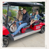 a group of people sitting around a car