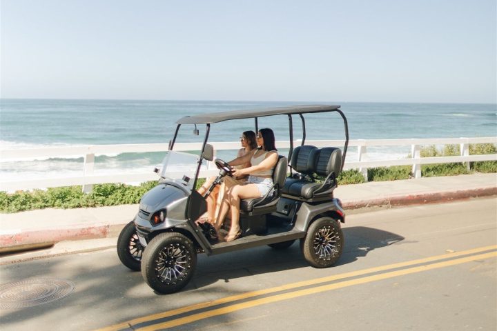 a motorcycle parked on top of a sandy beach next to the ocean