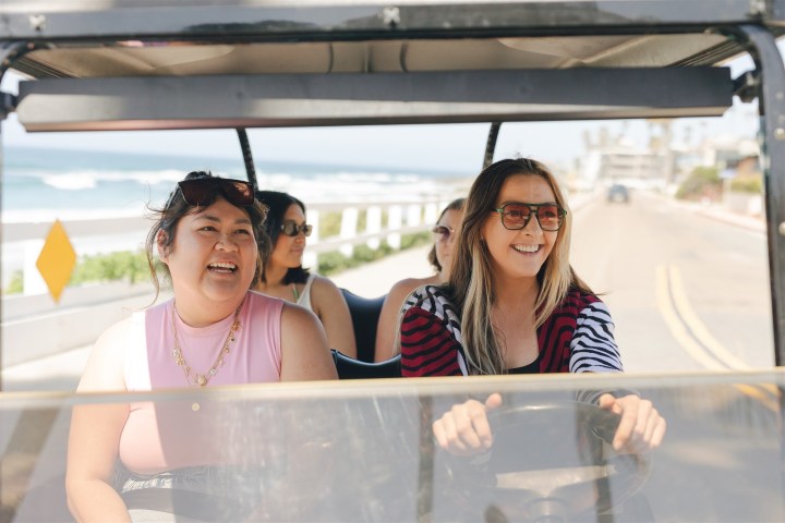 a couple of people that are sitting in front of a window