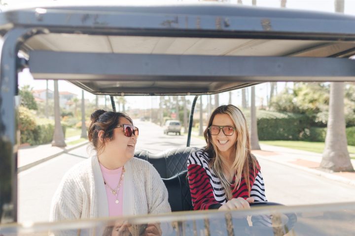 a man and woman sitting next to a window